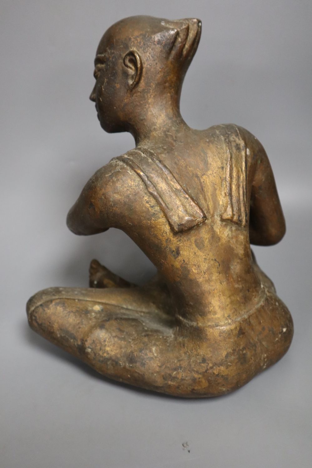 A South East Asian gilt bronze seated figure of a drummer, height 27cm